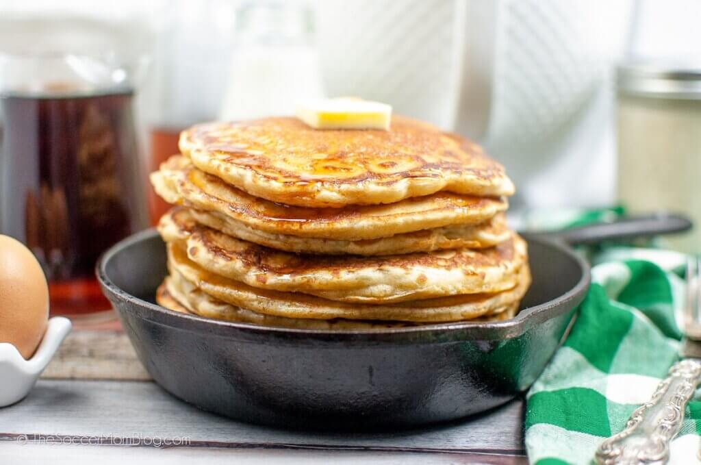 cast iron skillet stacked with fluffy sourdough pancakes