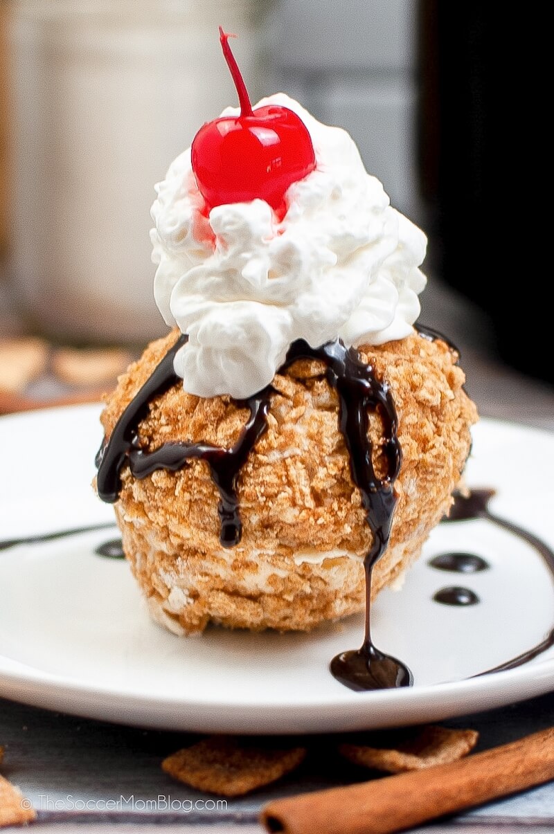 scoop of fried ice cream on plate with whipped cream and chocolate syrup