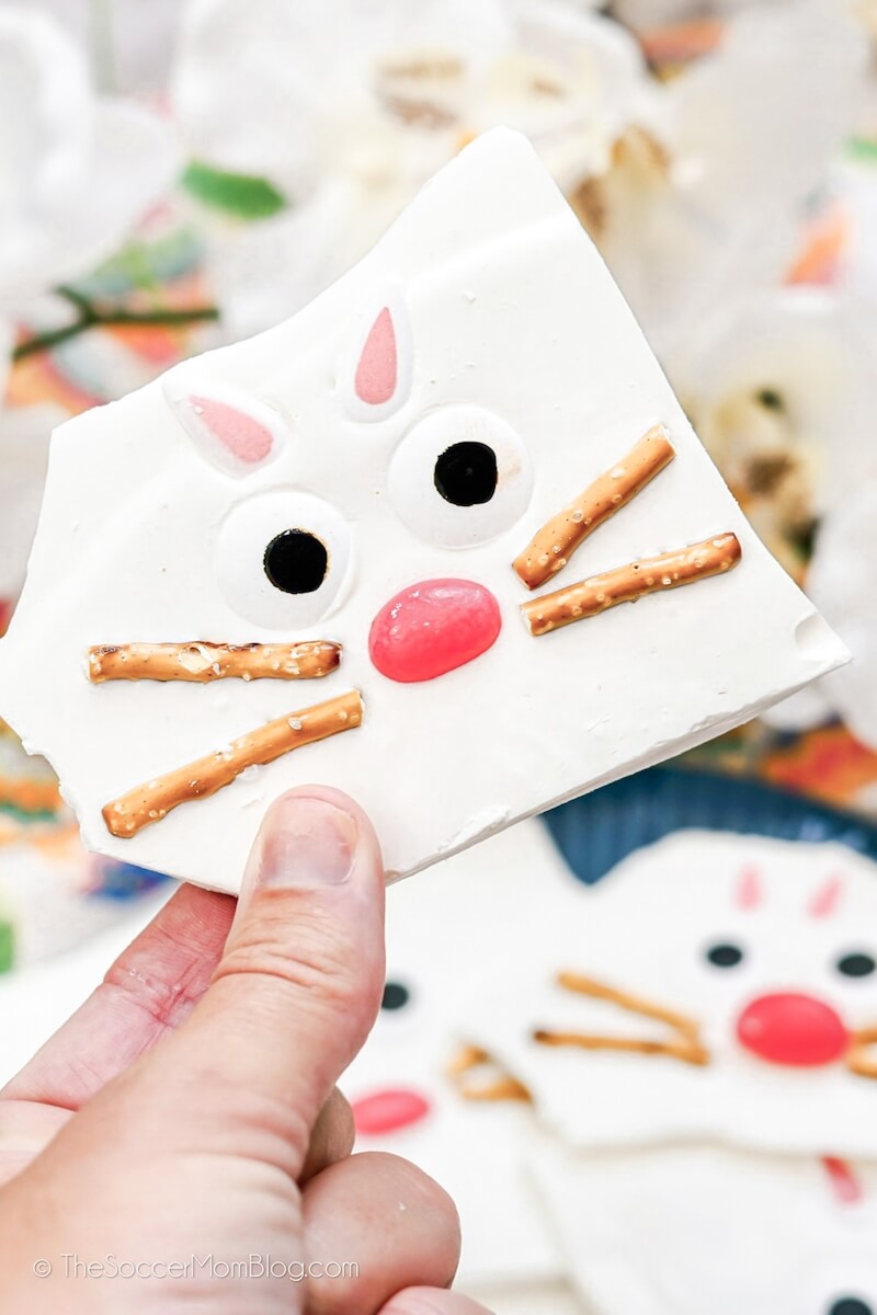 holding up a piece of Easter bunny white chocolate bark
