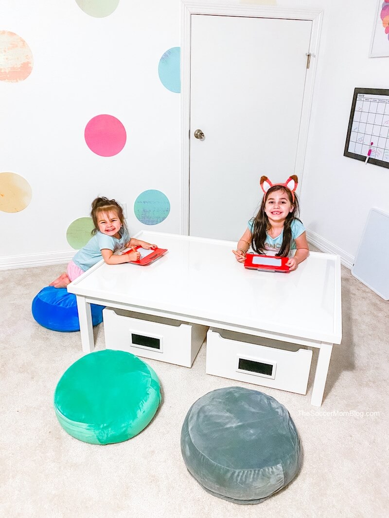 two little girls at an activity table in home school