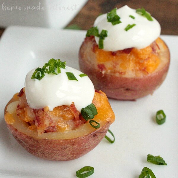 small potato bites with cheese and sour cream on top