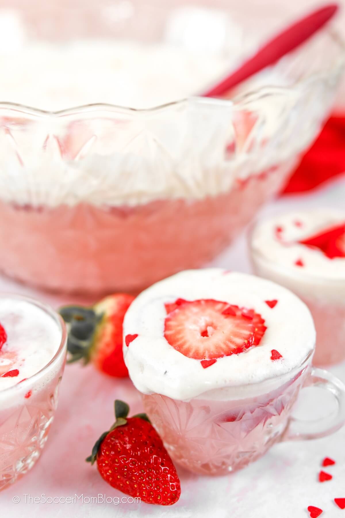 glass bowl and cups filled with strawberry Valentine's party punch