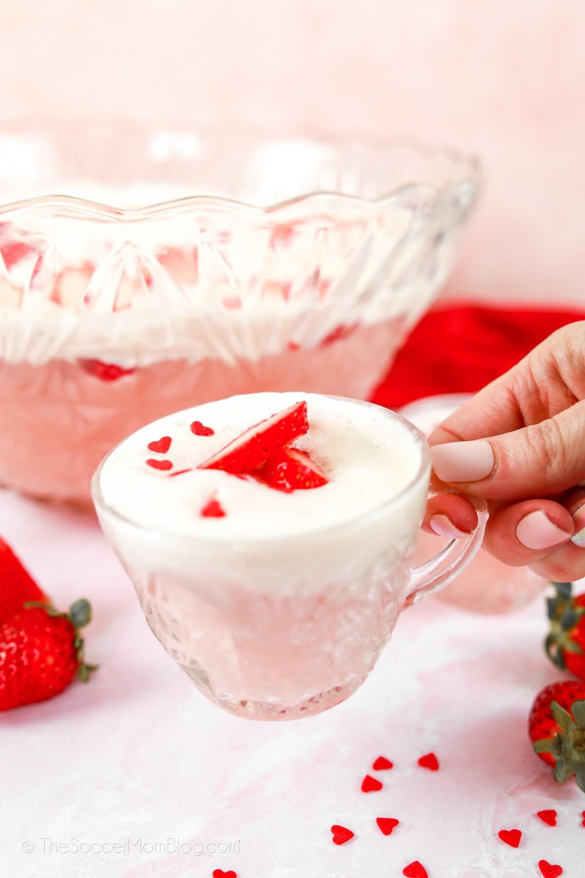 holding a mug of Valentine party punch