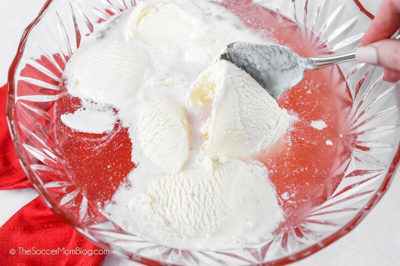 scooping ice cream into Valentine punch bowl