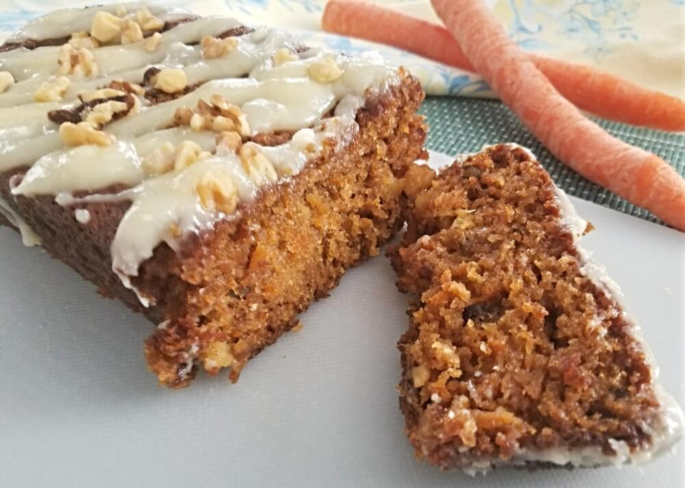 carrot loaf with icing and chopped pecans on top