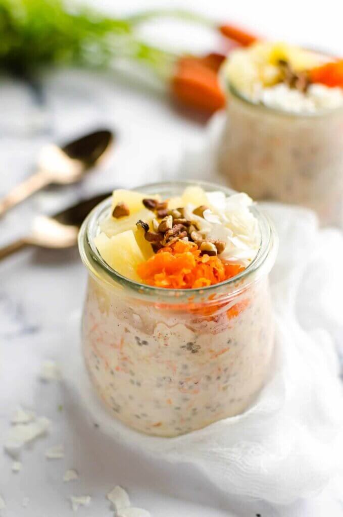 jar of carrot cake oatmeal with fruit and nuts on top