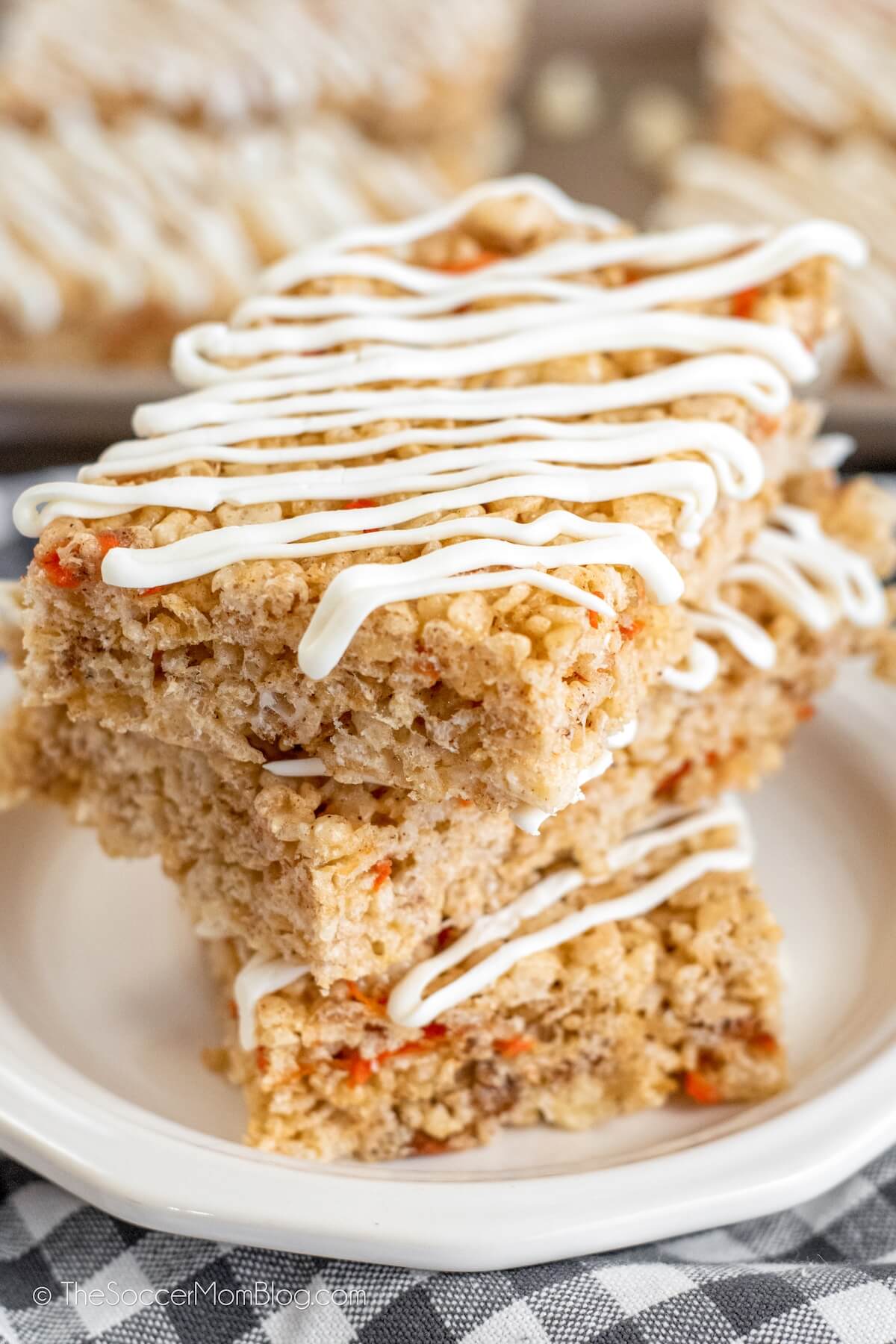 stack of homemade carrot cake rice krispie treats with cream cheese icing