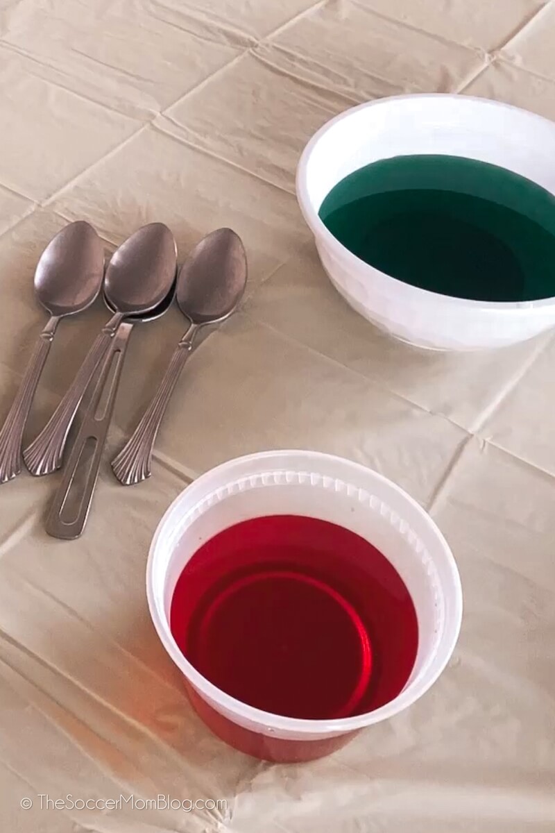 bowls of red and green homemade Easter egg dye on table