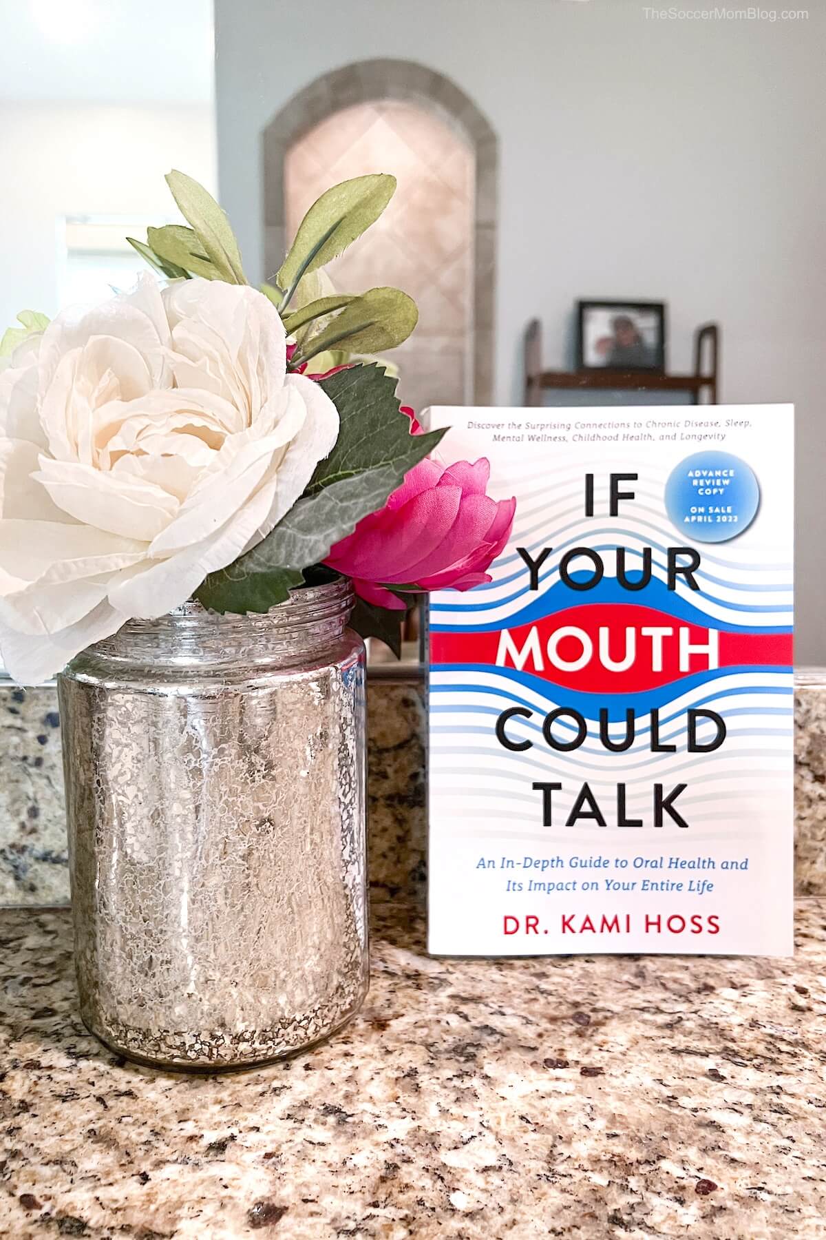 flowers on bathroom counter and book titled "If Your Mouth Could Talk"