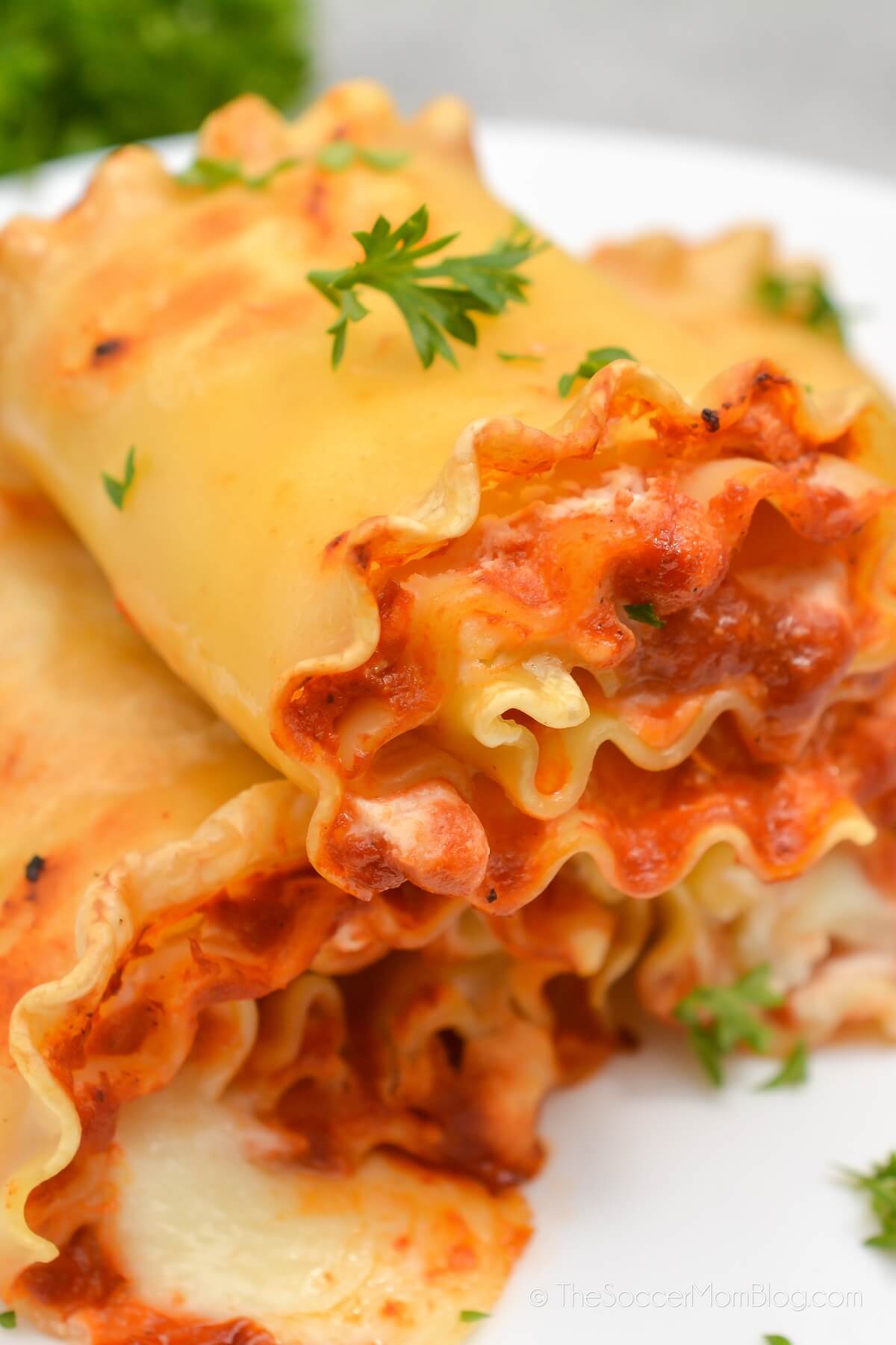 lasagna roll ups stacked on a plate