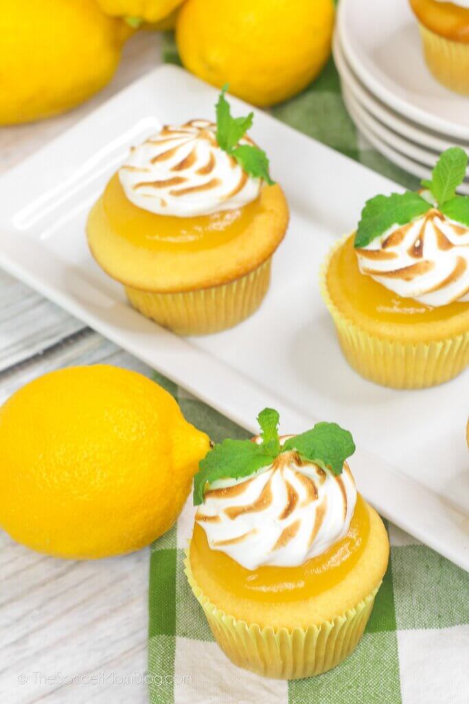 plate of lemon meringue cupcakes with lemon curd and toasted frosting