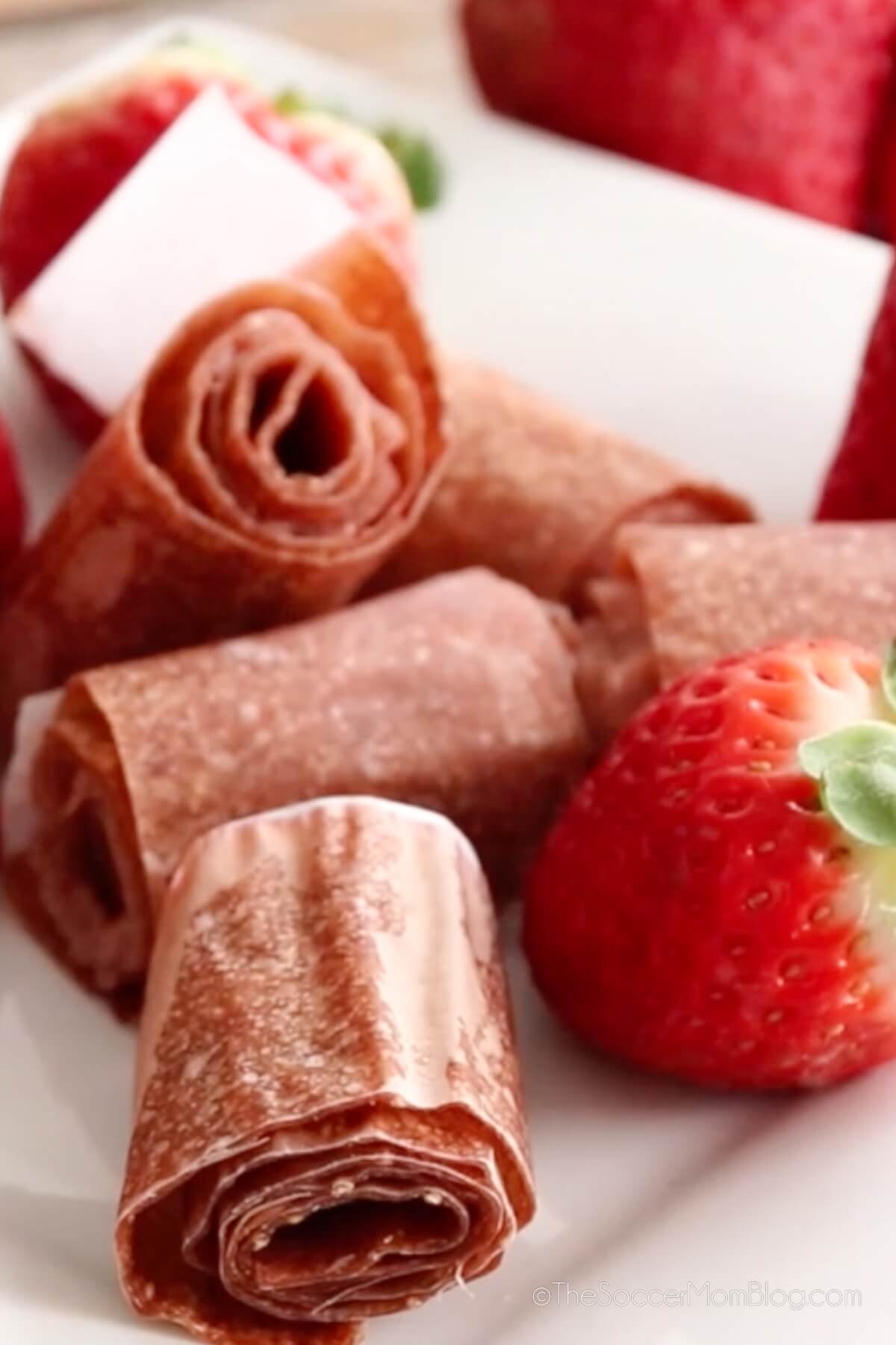 pile of homemade strawberry fruit leather roll-ups.