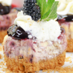close up of a mini blackberry cheesecake with bite missing