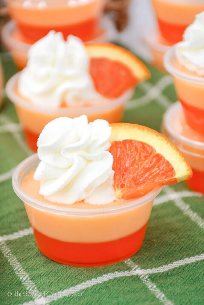 Creamsicle Jello Shots with whipped cream and orange slices