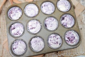 baking miniature blackberry cheesecakes in a muffin pan