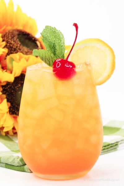 orange peach cocktail with cherry