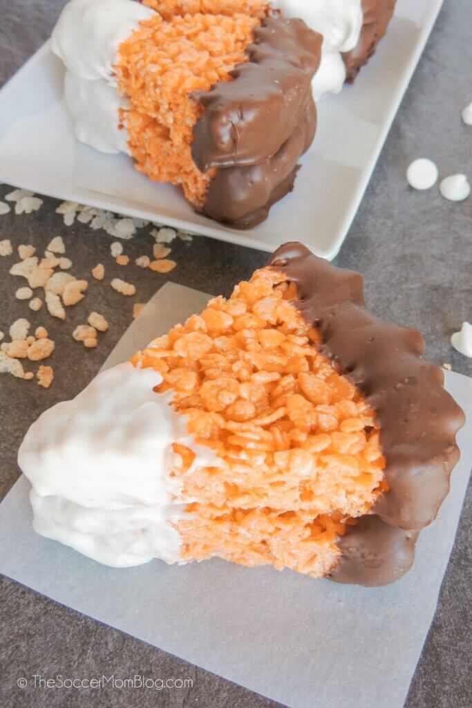 Candy Corn Rice Krispies stacked on parchment paper