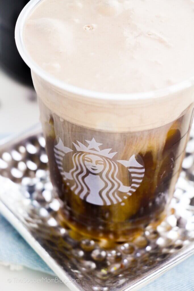 cold brew coffee in Starbucks cup, topped with chocolate cold foam