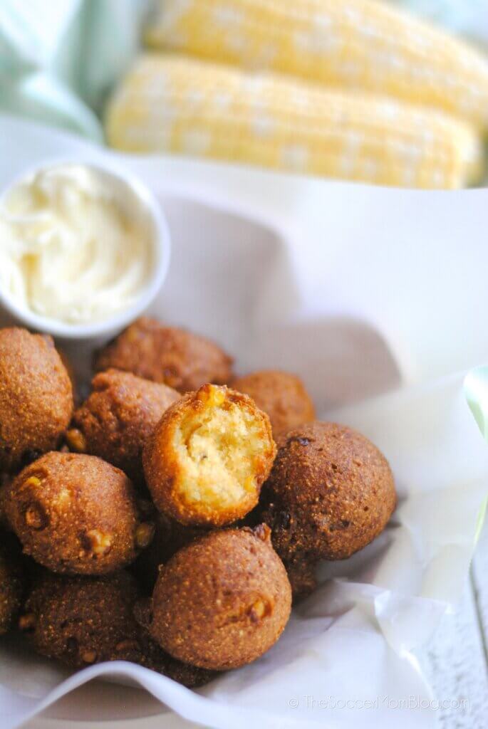 basket of hush puppies with corn in background