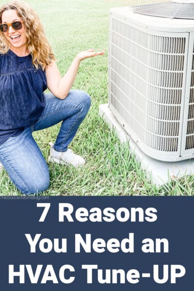 woman kneeling next to AC unit; text overlay "7 Reasons You Need an HVAC Tune-Up"