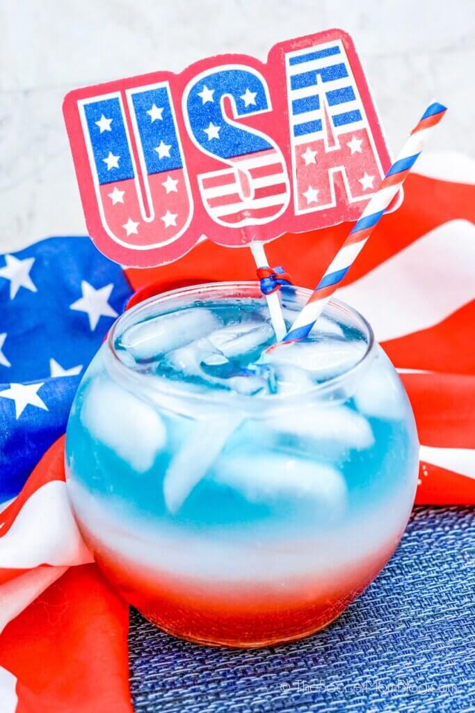 red white and blue layered drink in a fishbowl