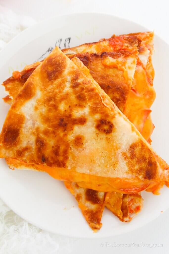 A stack of Pizza Quesadillas, with pepperoni and melty cheese