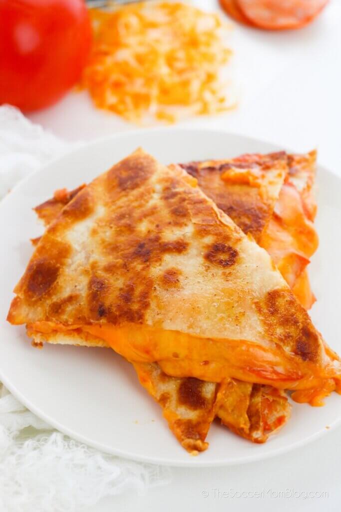 A stack of quesadilla slices with pizza fillings