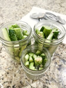 pint jars with sliced cucumbers, to make refrigerator pickles