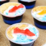 blue jello shots topped with gummy sharks