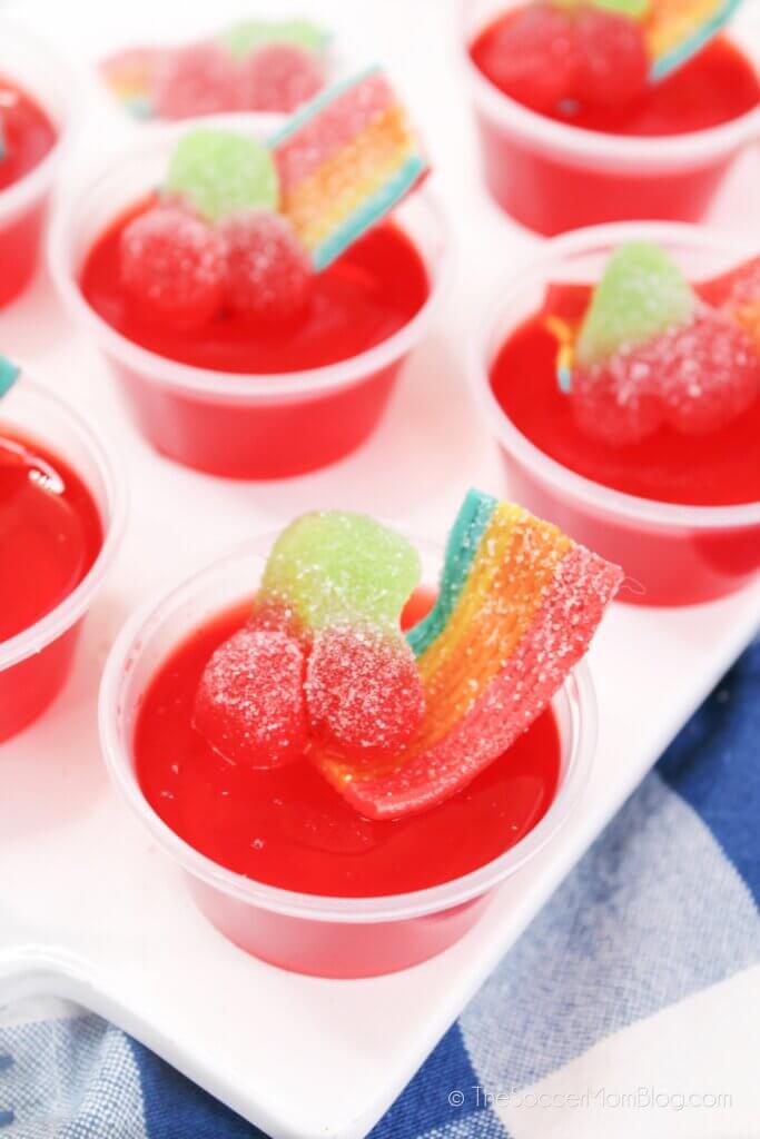 A tray of Sour Cherry Jello Shots topped with sour cherry candy