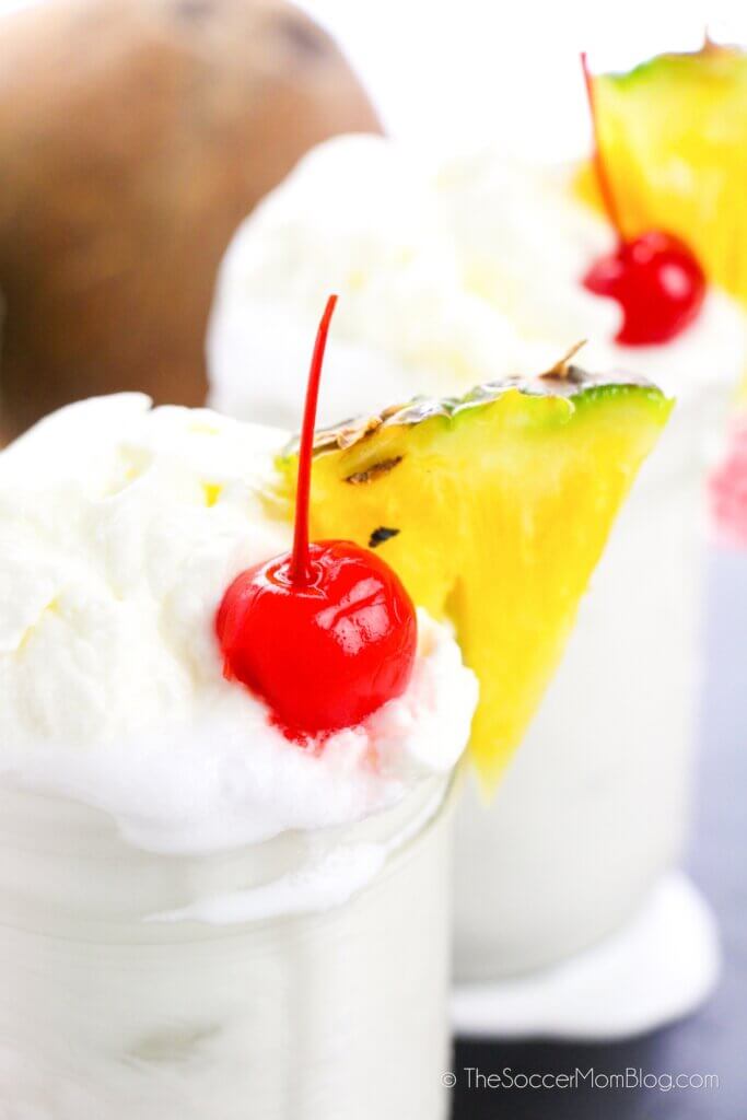 top down view of pina colada topped with whipped cream and a cherry