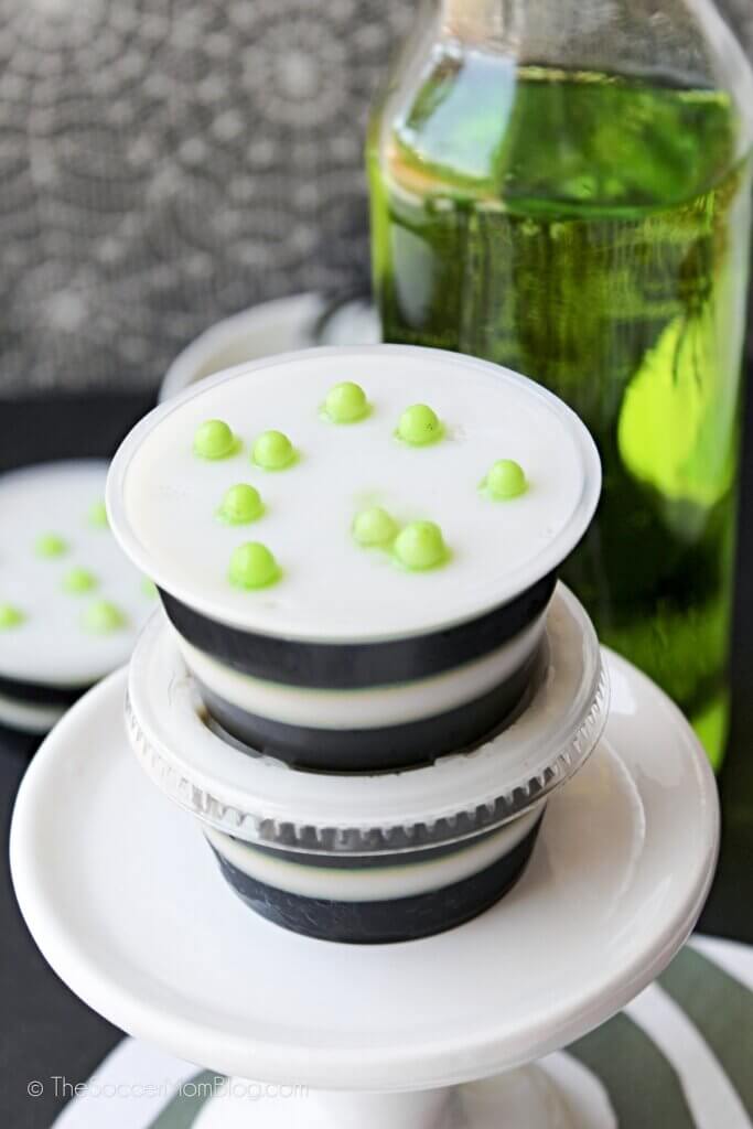 black and white layered jello shots with green sprinkles