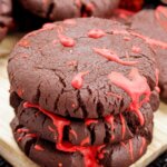 stack of three chocolate cookies with red frosting that looks like blood (for Halloween)