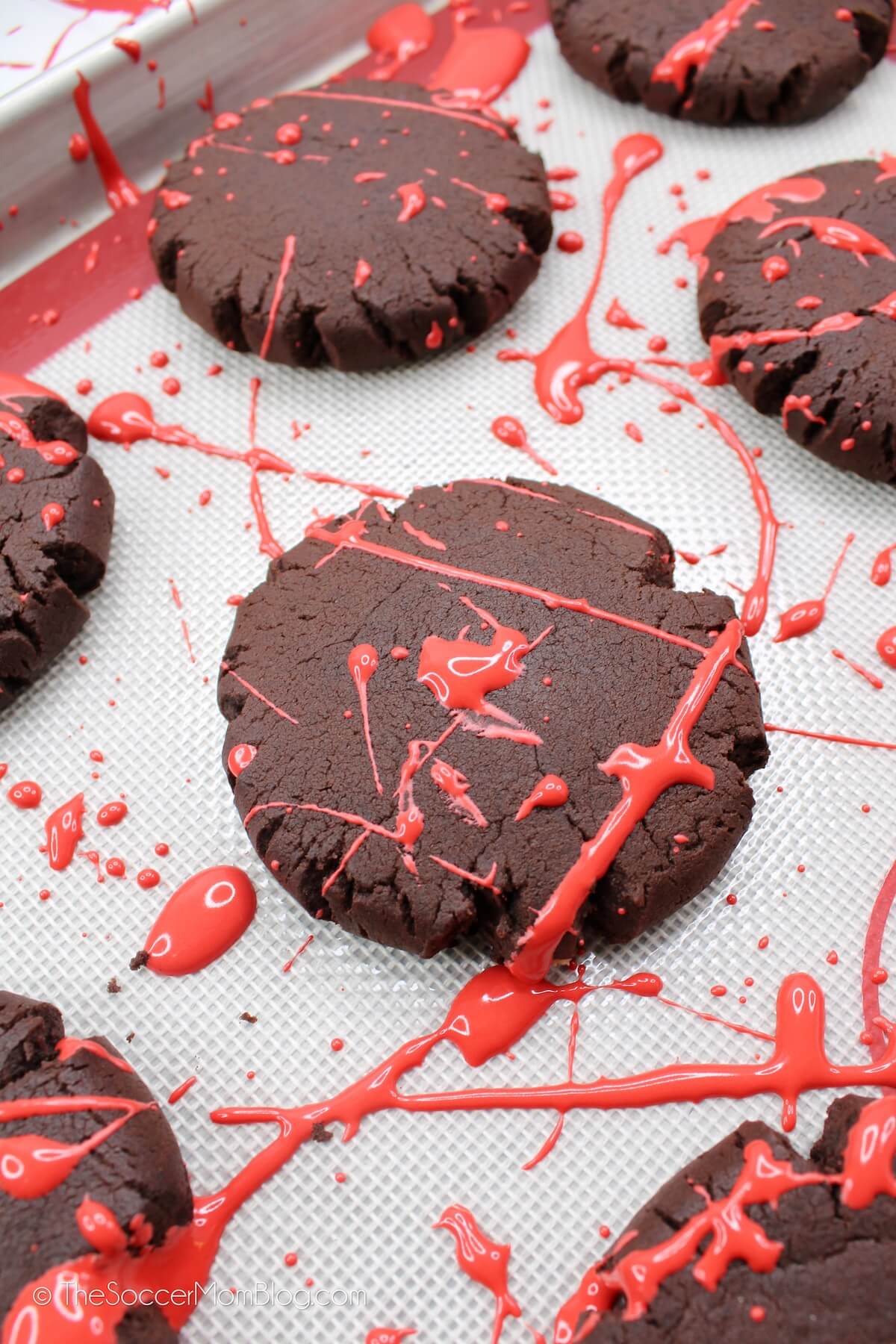 chocolate cookies with splatters of red icing