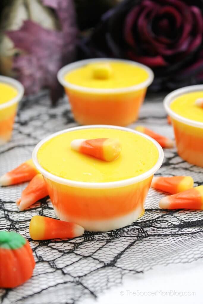 Two completed Candy Corn Jello Shots on a decorated table
