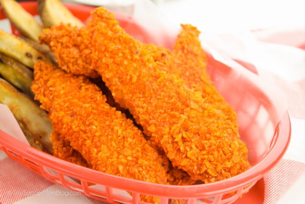 Doritos crusted Chicken Tenders and fries in a fast food basket