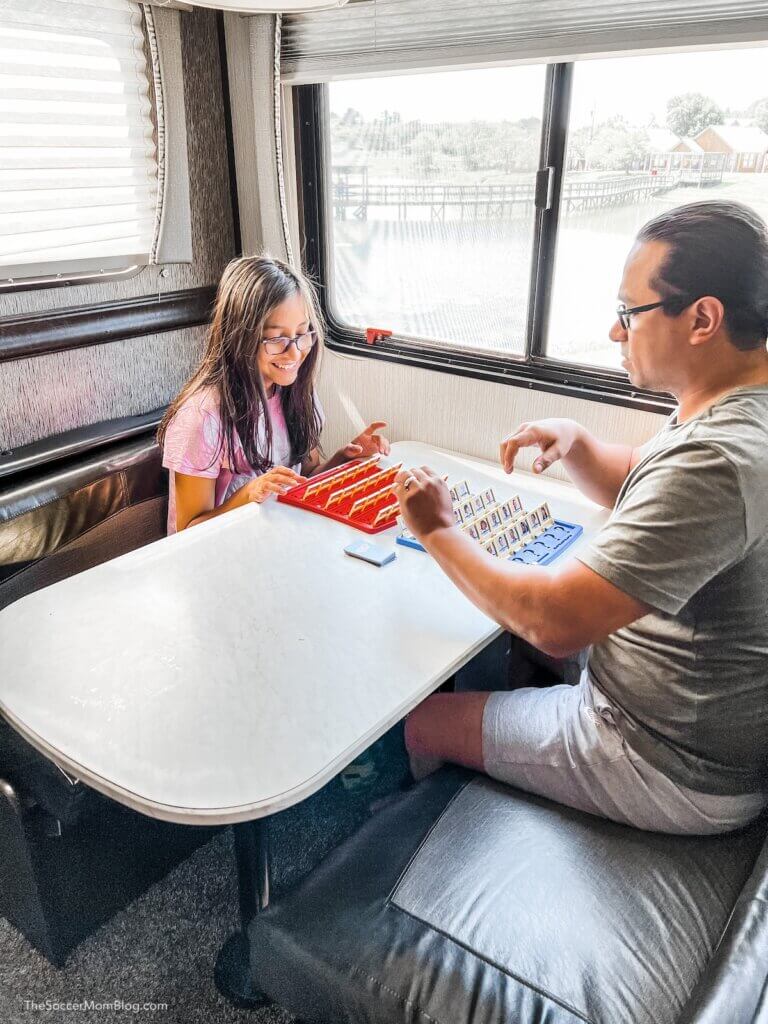 dad and daughter playing a board game inside an RV