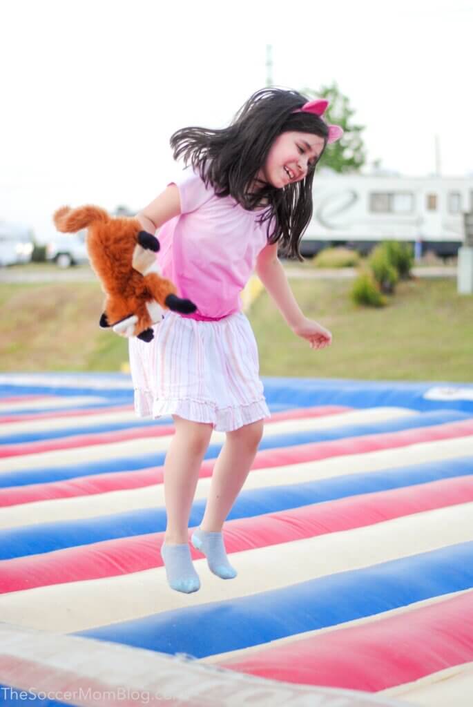 little girl jumping on a bounce pad
