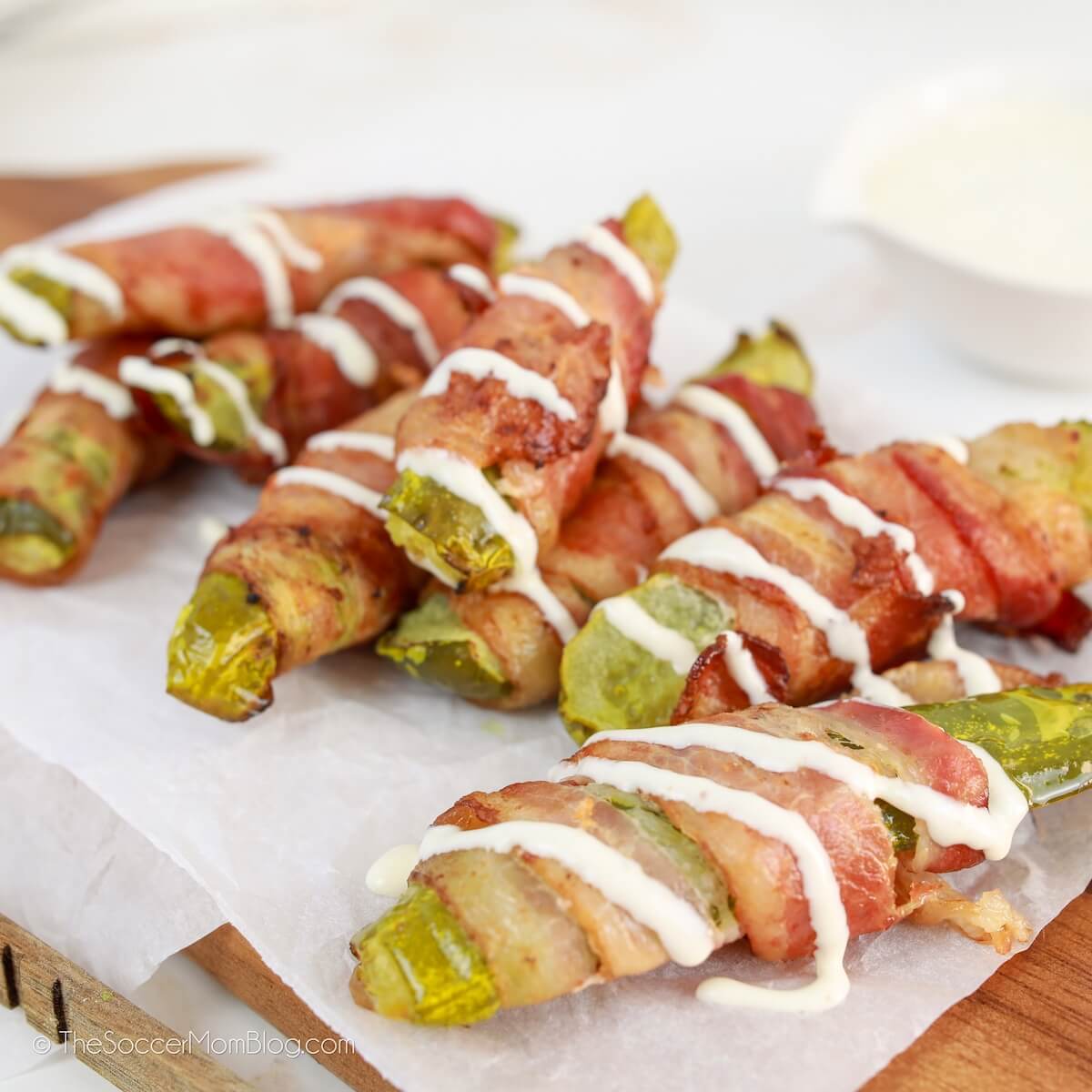 platter of pickles wrapped in crispy bacon, drizzled with ranch