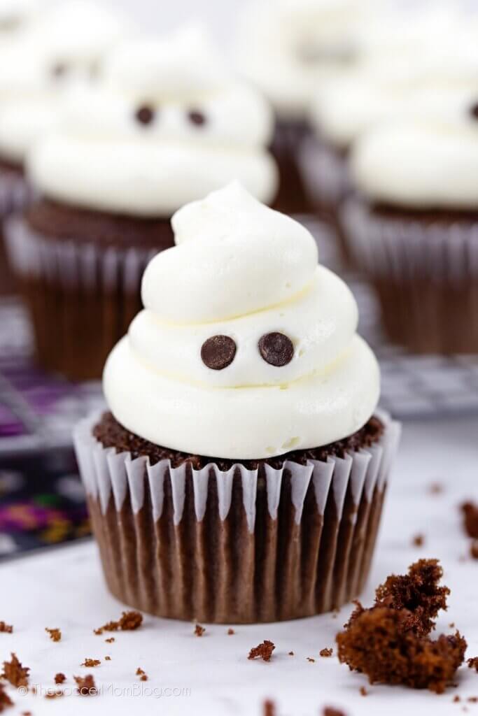 ghost cupcakes made with a swirl of vanilla frosting and chocolate chip eyes