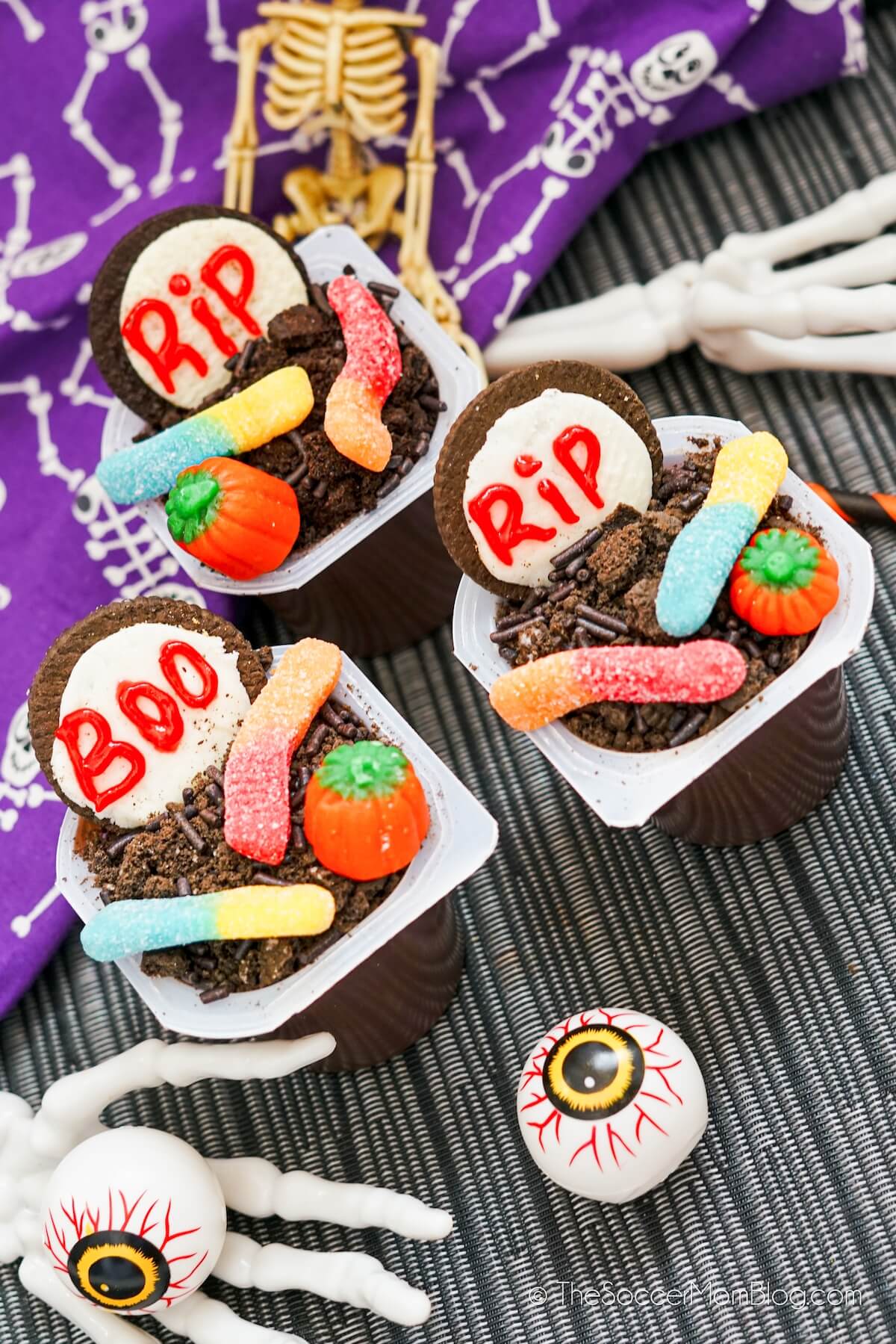 Halloween pudding cups made with gummy worms and Oreos on top