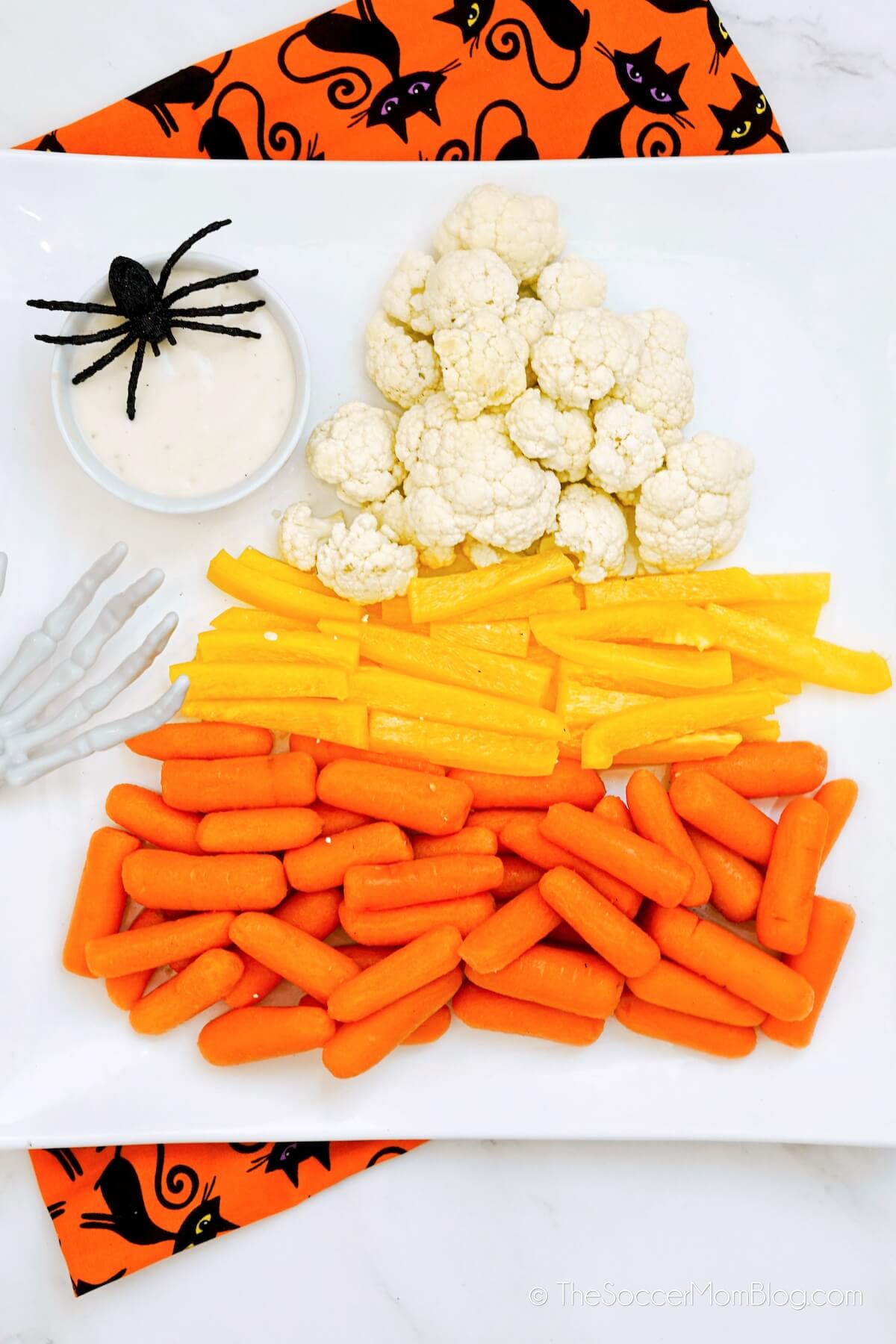 Halloween vegetable tray shaped like a candy corn