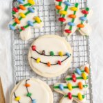 wire rack with homemade cookies decorated with Christmas light designs