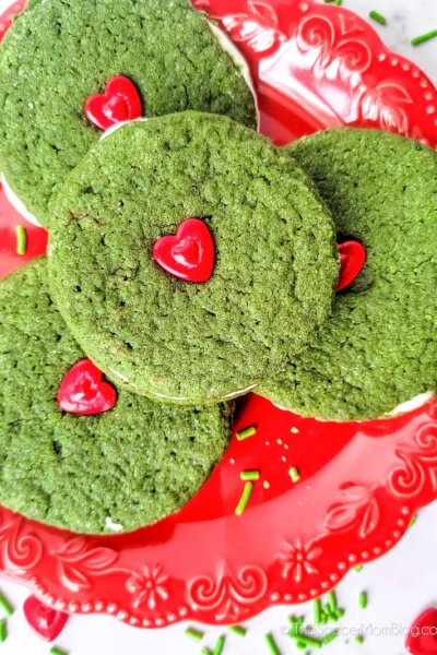 A plate of Grinch Cookie Sandwiches