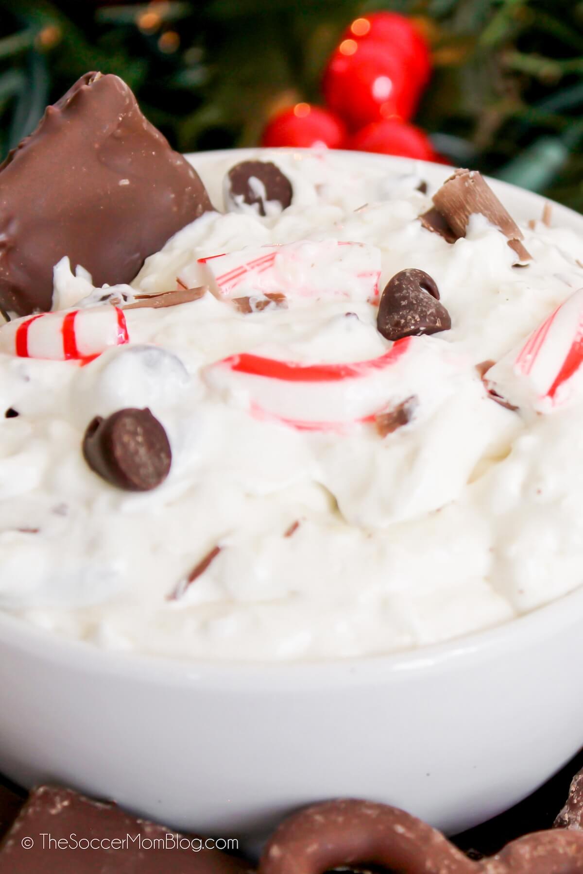 close up of peppermint bark cheesecake dip in bowl