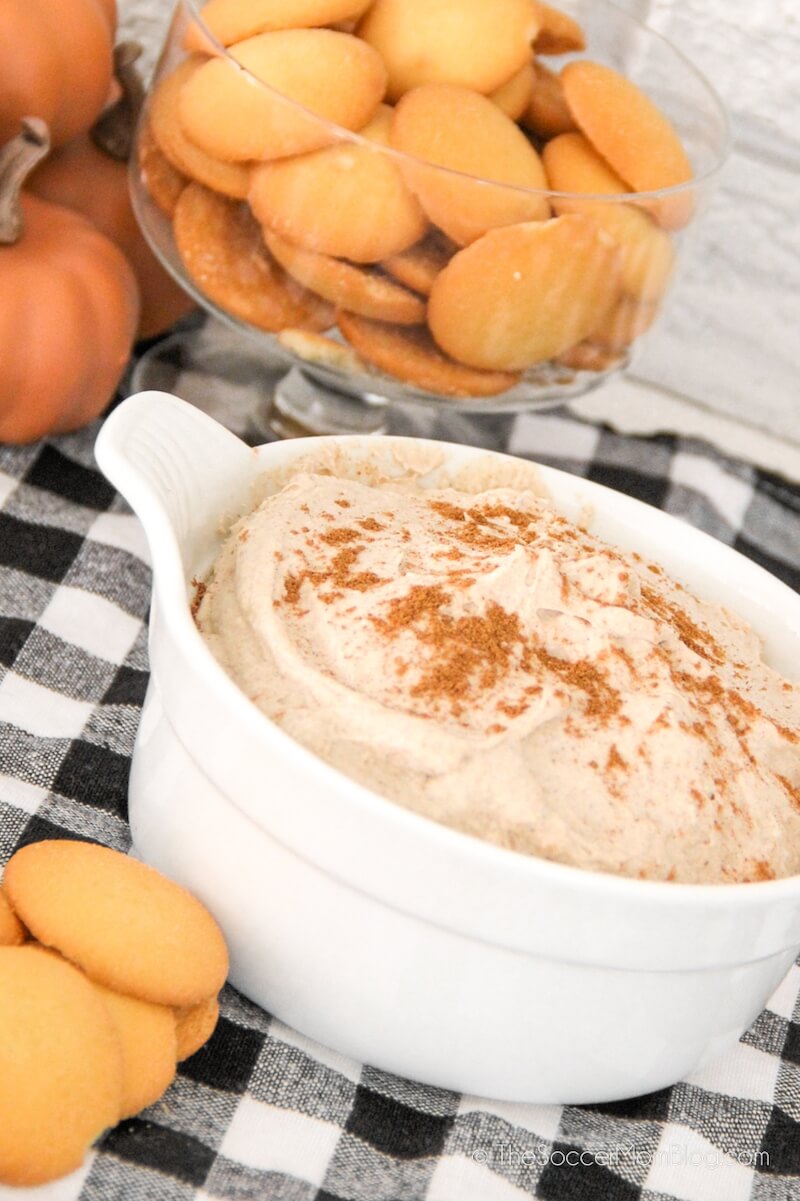 Bowl of pumpkin dessert dip with a bowl of cookies in background