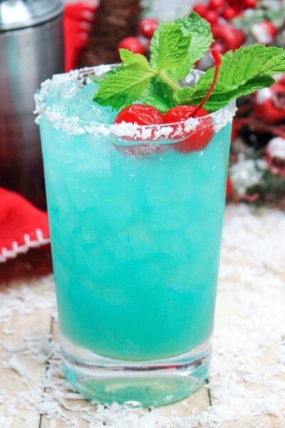 blue cocktail with a sugar rim, with winter background