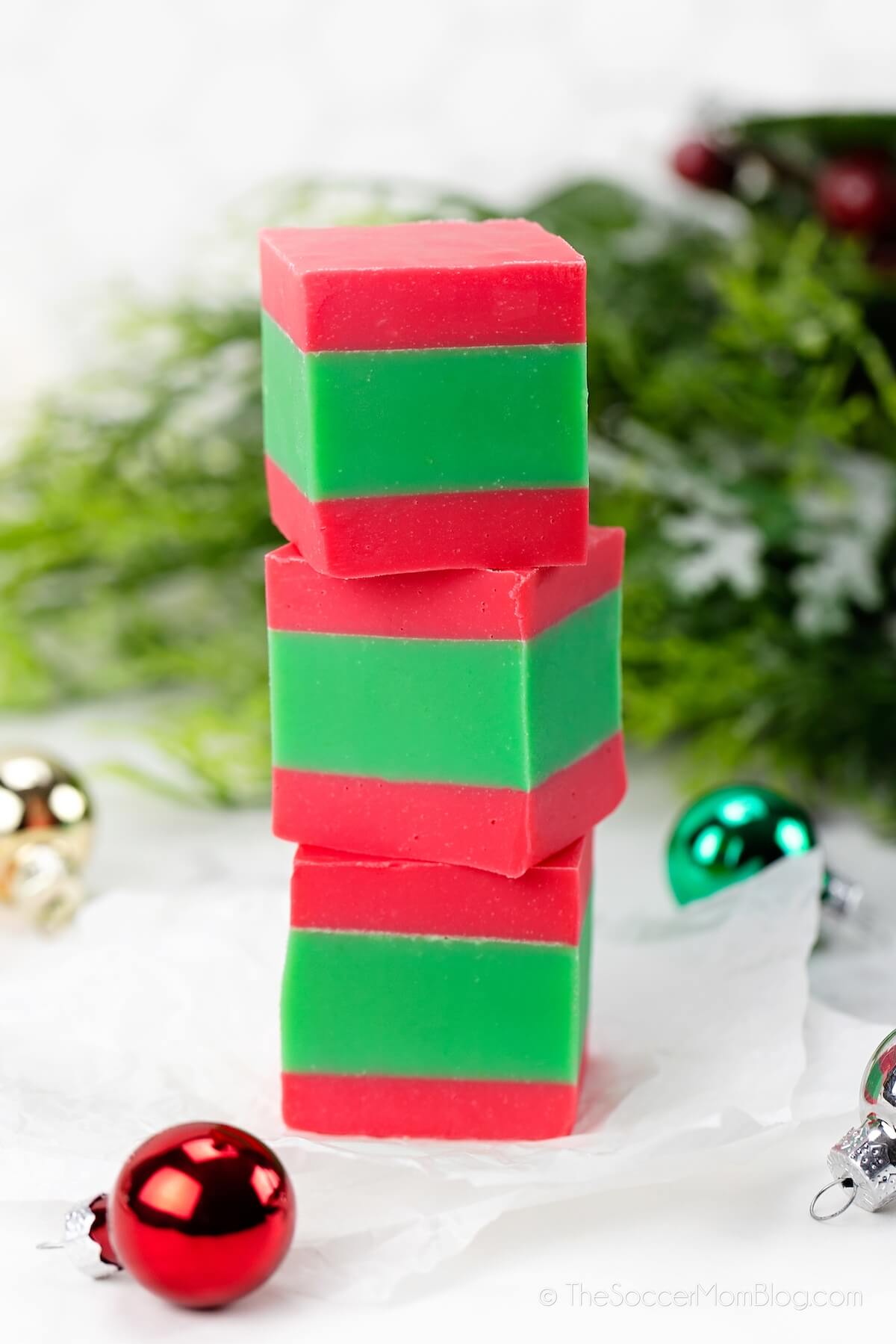3 squares of red and green Christmas fudge stacked on top of each other