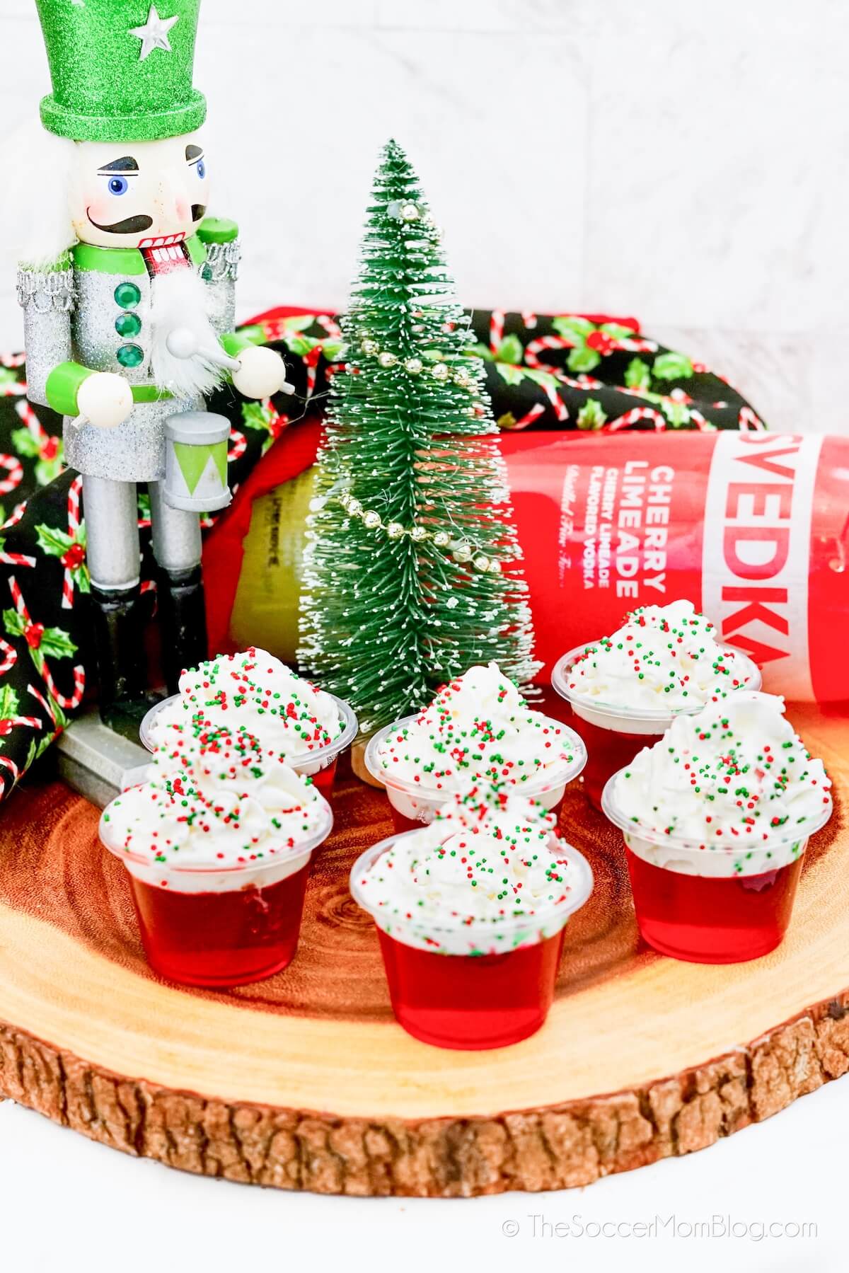 platter of red holiday jello shots with Christmas decorations