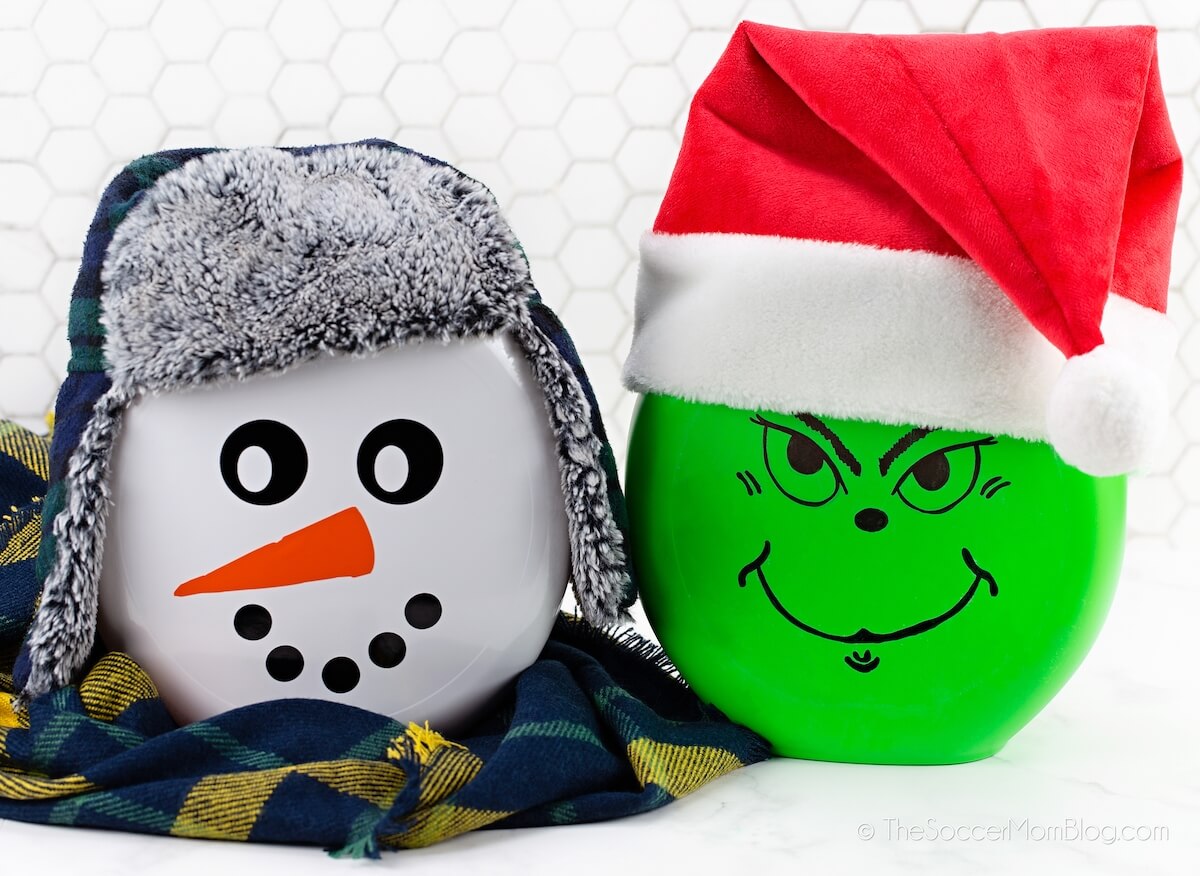 Grinch and snowman Christmas lanterns made from laundry pod containers